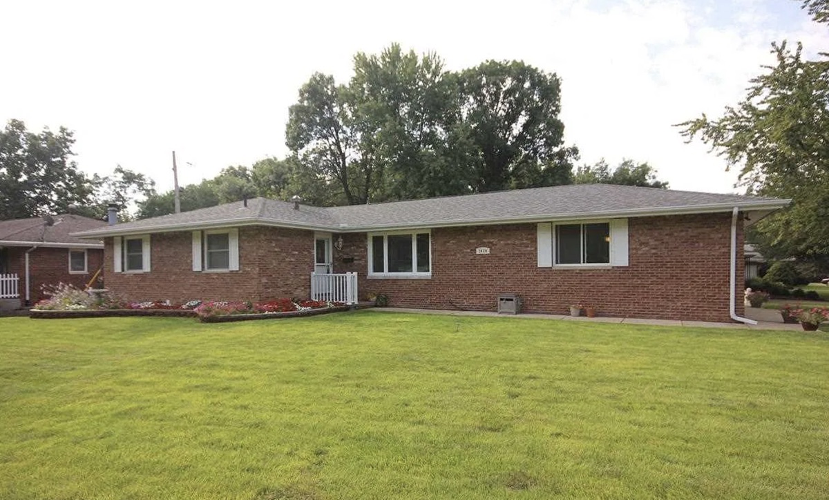 Red brick ranch house with white shutters bought by TruOffer
