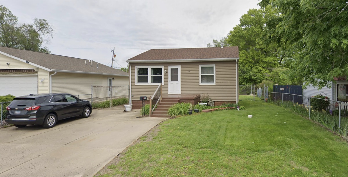 Tan house with front steps and a driveway bought by TruOffer