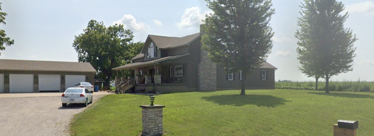 Country home with a covered porch and detached garage bought by TruOffer